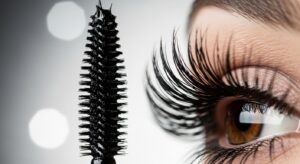 High-definition macro shot of a mascara wand and lengthened eyelashes, showcasing the fiber technology for maximum volume and definition.