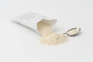 A silver spoon and a supplement packet containing psyllium husk powder for the 9 Best Psyllium Husk Powders Daily Fiber Guide.