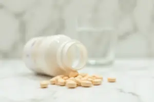 Digestive enzyme supplements on a marble surface, featured in the 8 Best Digestive Enzymes for Bloating and Dairy Sensitivity guide.