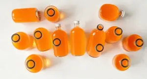 A premium collection of clear bottles of liposomal Vitamin C supplements arranged on a marble surface for our expert guide.