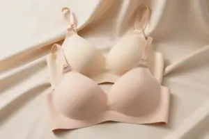 Smooth nude and blush t-shirt bras that don't gap laid on beige satin