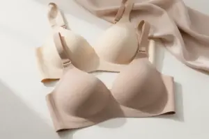 Supportive wireless bras for DDD+ cups in neutral tones arranged on a sunlit surface