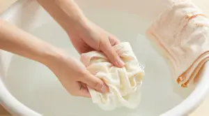 Delicate lingerie being gently hand washed in cool water